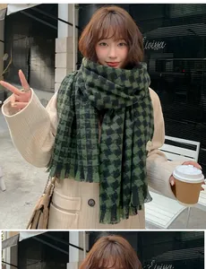 Close-up view of a warm green and black houndstooth checkered winter scarf for women