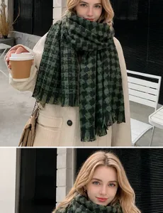 Detail of dark green houndstooth scarf with fringe edge and white brand label