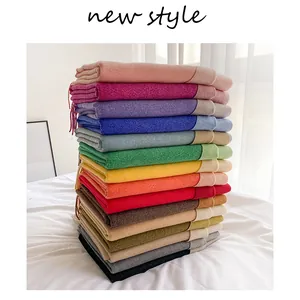 Detailed view of colorful cashmere scarves with fringed edges and multi-color options