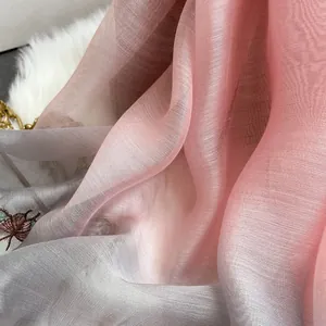 Detail of gradient silk wool scarf with intricate insect embroidery and sheer texture