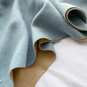 Close-up of double-sided cashmere scarf showing light blue and beige wool texture