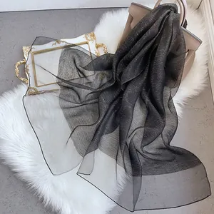 Elegant black silk wool scarf with shimmering gold metallic threads for evening wear