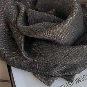 Elegant black silk wool scarf with vertical gold metallic threads and wrinkled texture