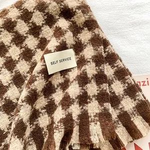 Classic brown and beige houndstooth scarf with soft cashmere-like texture and brand tag