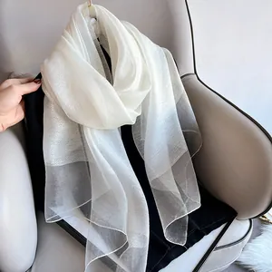 Close-up of elegant white silk wool shawl with shimmering pearlescent glitter effect