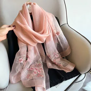 Pink silk wool scarf with intricate flower embroidery and lightweight translucent fabric