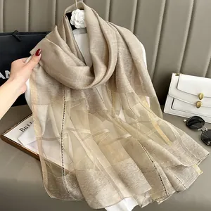 Detailed close-up of champagne silk mohair shawl featuring semi-transparent striped texture