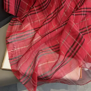 Close-up of red plaid silk scarf featuring metallic gold thread and Butterfly printing