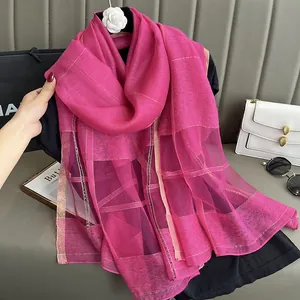 Detail of rose pink silk mohair scarf featuring gold stripe patterns and texture