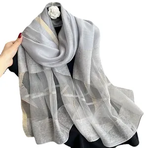 Elegant silver silk mohair shawl with gold metallic grid patterns and fringe details