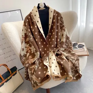 Close-up of double-sided cashmere shawl with floral jacquard and polka dot patterns