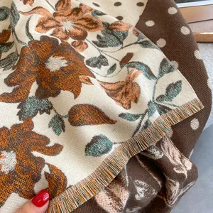 Detail of floral and polka dot cashmere-feel scarf with colorful fringe edges