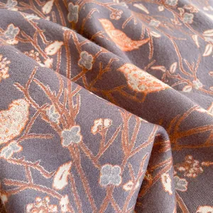 Macro detail of French vintage cashmere-like scarf with floral bird pattern in grey-purple