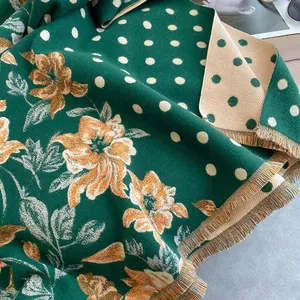 Detail of dark green floral shawl showing reversible vintage flower and polka dot patterns