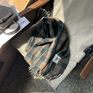 Detail of vintage plaid scarf with fringe edge and soft polyester fiber texture