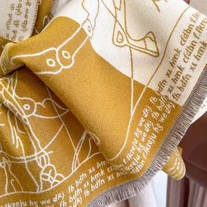 Detailed macro view of the ginger yellow jacquard knit scarf with soft tassels