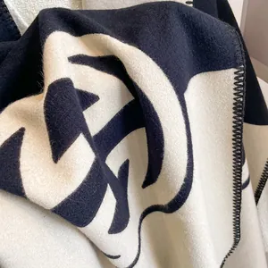 Close-up of double-sided cashmere-like scarf showing soft texture and blanket stitch edges
