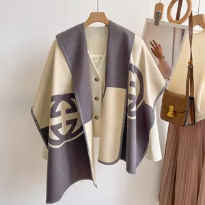 Two-tone cashmere-style winter shawl with geometric logo pattern and stitched edges