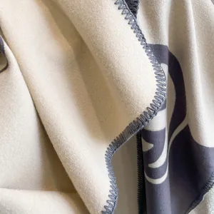 Detailed close-up of soft cashmere-like scarf fabric with elegant blanket stitch edging