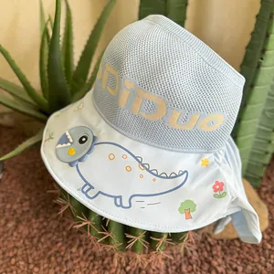Close-up of kids light blue sun hat with dinosaur prints and breathable knit fabric