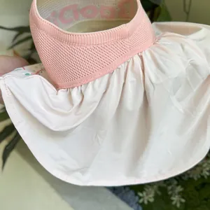 Detail of pink sun hat with breathable mesh and ruffle neck protection flap
