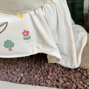 Close-up of baby sun hat featuring cartoon star prints and breathable mesh detail