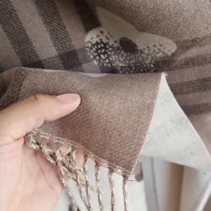 Macro detail of soft cashmere-feel fabric with vintage plaid and floral patterns