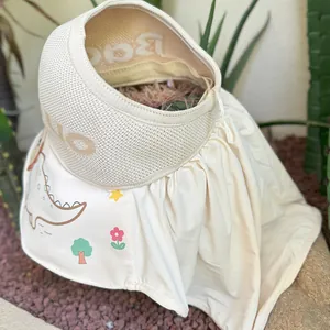 Detail of kids sun hat featuring wide brim with dinosaur print and knit Hello headband