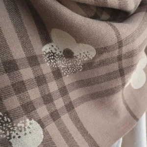 Close-up of elegant coffee checkered cashmere scarf with delicate white floral patterns