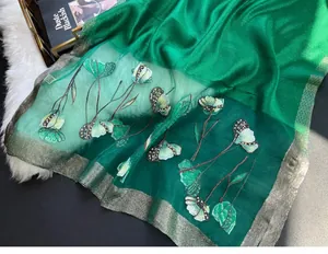 Detailed embroidery and beadwork on a dark green silk blend shawl with metallic gold trim