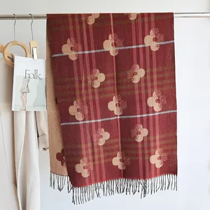 Close-up of elegant burgundy pashmina shawl with tassel detail and floral print