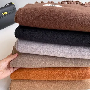 Thick tasseled scarves in six solid colors with rich texture and a warm stylish look