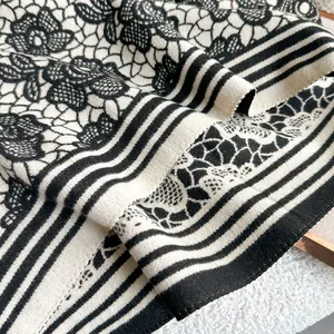 Detail showing the thick knit texture and retro rose lace pattern of the cashmere-like shawl