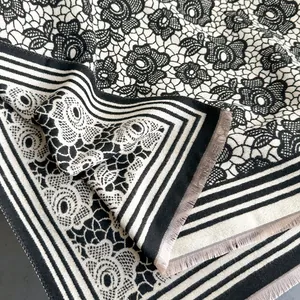 Classic black and white floral cashmere shawl with elegant rose patterns and fringe detail
