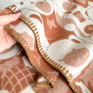 Thick jacquard bear scarf in brown and beige featuring soft cashmere-like texture