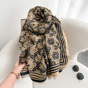 Close-up of retro floral pattern cashmere-like scarf with fringe and soft knit texture