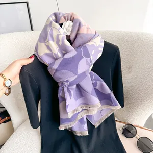 Dettaglio della sciarpa pashmina viola a fiori con morbide frange sui bordi
