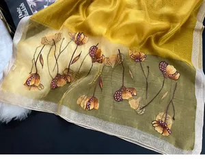 Detail of floral embroidery and sequin accents on a silk blend gradient scarf