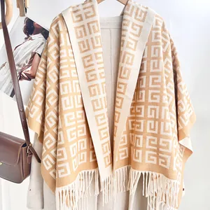 Detailed view of beige cashmere feel shawl with geometric G-pattern and fringe trim