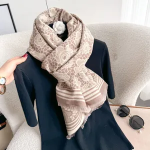 Detail view of floral cashmere scarf with vintage roses, fringe edges and beige coffee tones