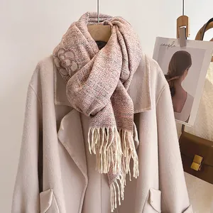 Thick camellia knit scarf with fringe in peach orange paired with wool coat