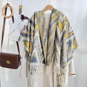 Detail of knitted shawl with geometric waves, tassel hem, and soft draping texture