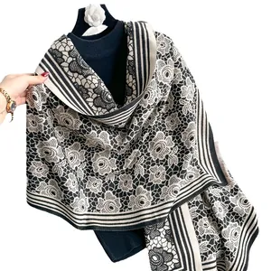 Elegant knit shawl featuring rose flower pattern and bold black and white stripes