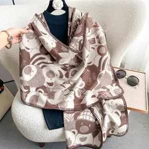 Close-up of thick bear pattern scarf with soft texture and high-quality stitched edges