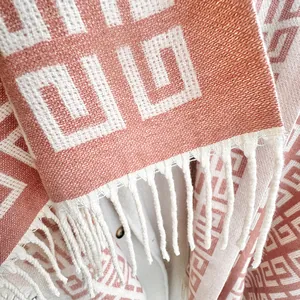 Winter shawl with red and beige geometric meander patterns and elegant tassels