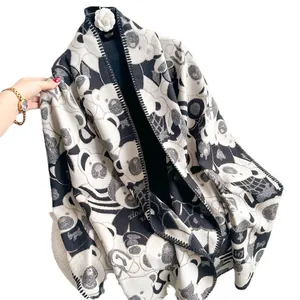 Thick black and white knit scarf with panda patterns and camellia brooch accessory