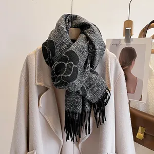 Close-up of thick camellia flower pattern scarf with elegant black tassels and texture