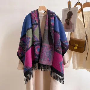 Detail of bohemian shawl with mandala prints, fringe tassels and knit texture
