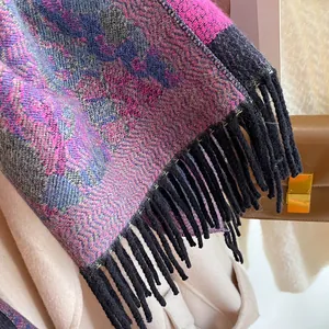 Close-up of bohemian fringed scarf with purple jacquard weave and thick texture