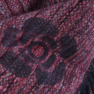 Macro view of luxurious camellia jacquard knit scarf fabric in deep red and black